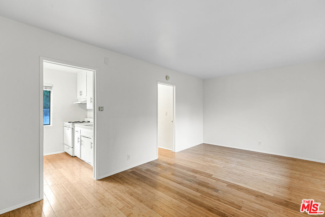 2637 South Centinela Avenue, Unit 13 Santa Monica, CA 90405 - Photo 5 of 15 a view of an empty room with wooden floor and a window