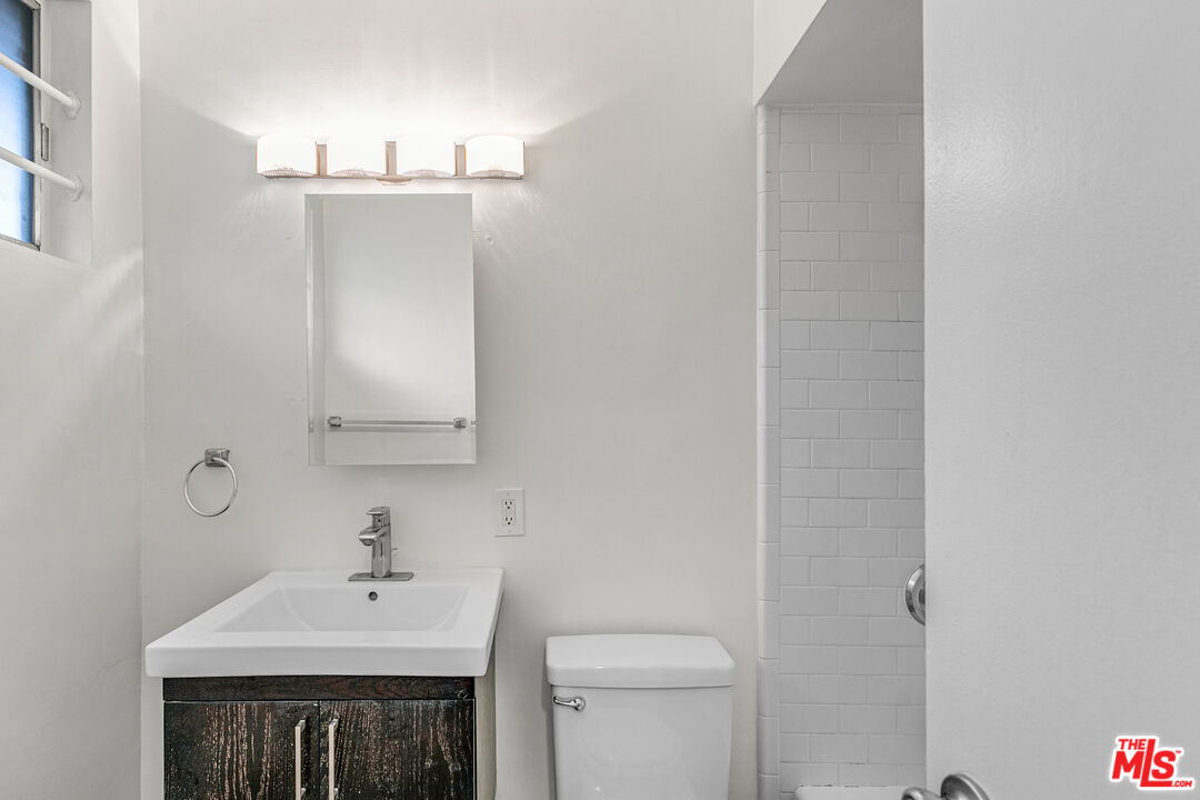 2637 South Centinela Avenue, Unit 13 Santa Monica, CA 90405 - Photo 10 of 15 a bathroom with a sink a toilet and mirror
