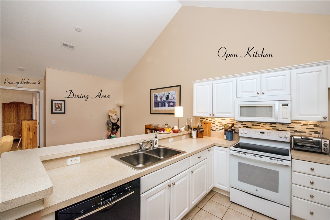 113 Life Style Lane Anderson, SC 29621 - Photo 16 of 28 This spacious kitchen, featuring a practical breakfast bar, flows seamlessly into the inviting dining area.