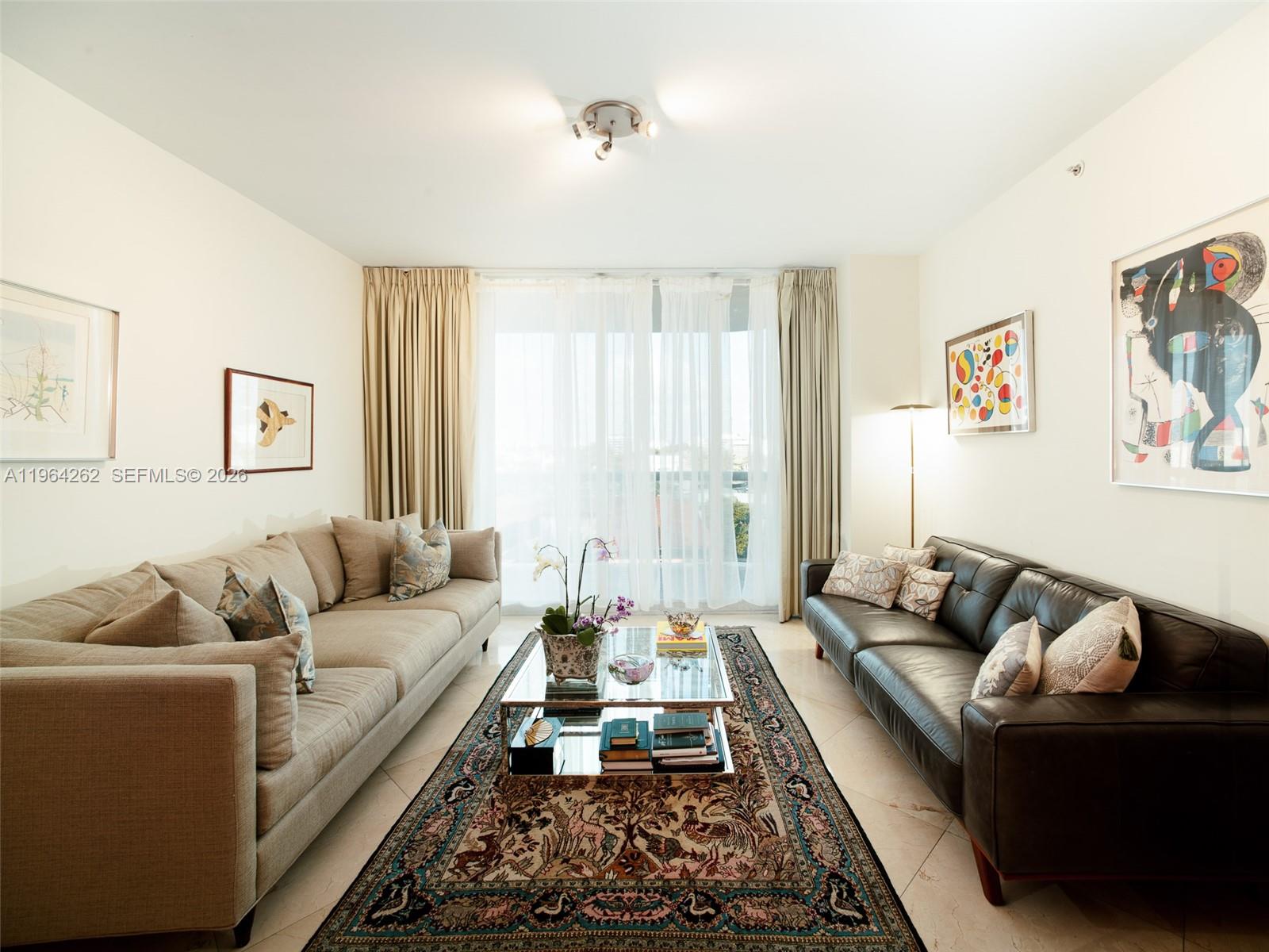 9595 Collins Avenue, Unit N5G Surfside, FL 33154 - Photo 2 of 12 a living room with furniture and a couch