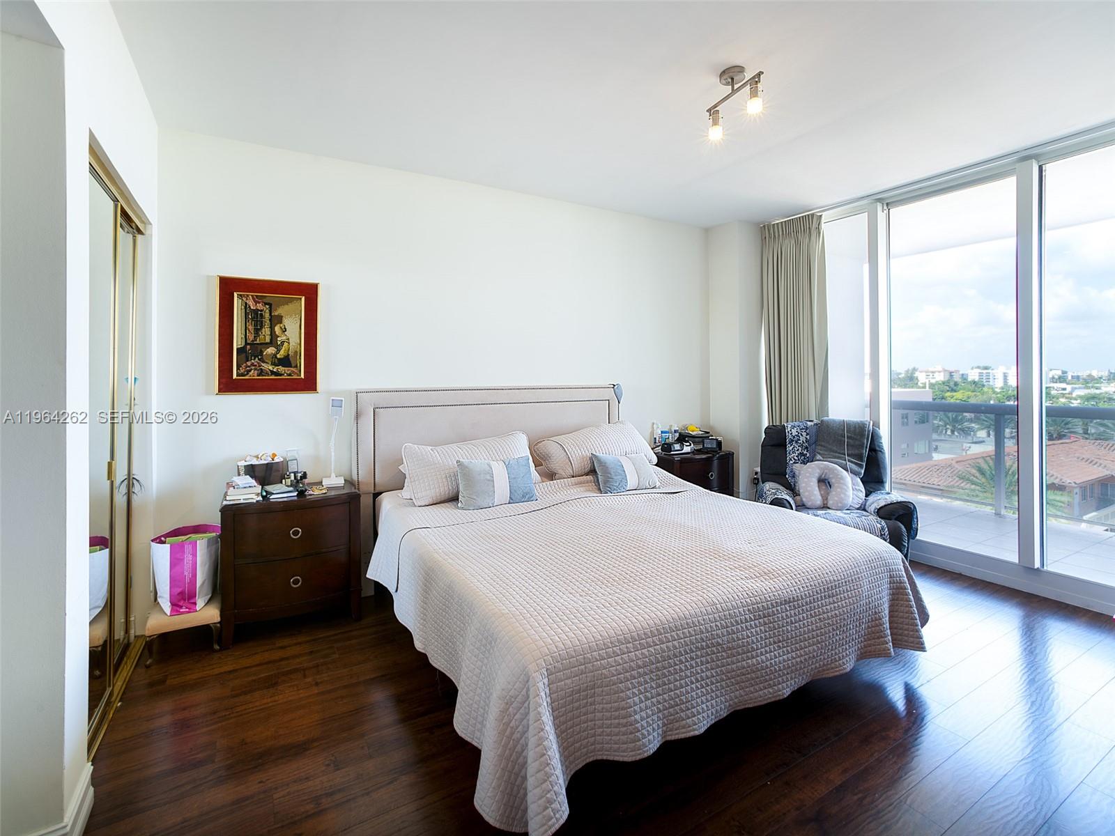 9595 Collins Avenue, Unit N5G Surfside, FL 33154 - Photo 8 of 12 a bedroom with a bed and wooden floor