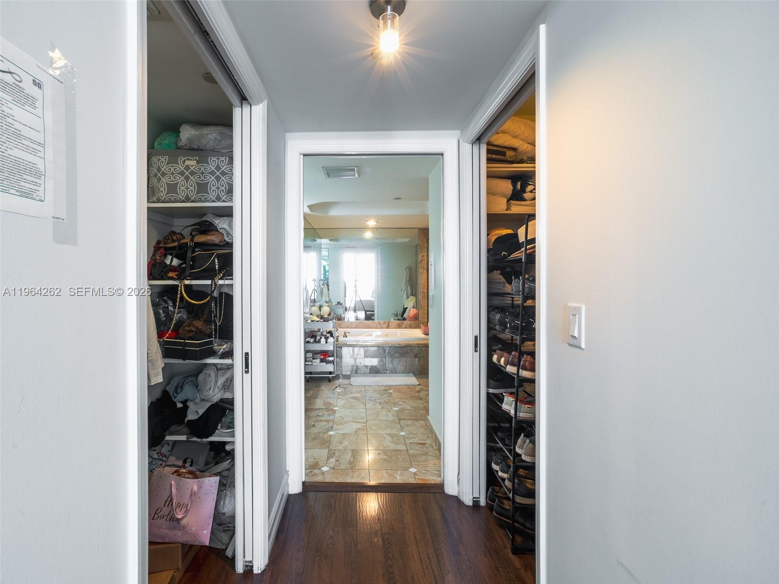 9595 Collins Avenue, Unit N5G Surfside, FL 33154 - Photo 10 of 12 a view of a hallway with wooden floor and closet