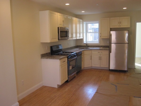 6 Baldwin Place Boston, MA 02113 - Photo 1 of 7 a kitchen with stainless steel appliances granite countertop a refrigerator a stove a sink and a microwave