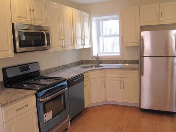 6 Baldwin Place Boston, MA 02113 - Photo 3 of 7 a kitchen with granite countertop cabinets stainless steel appliances and a wooden floor