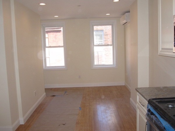 6 Baldwin Place Boston, MA 02113 - Photo 5 of 7 an empty room with wooden floor and windows