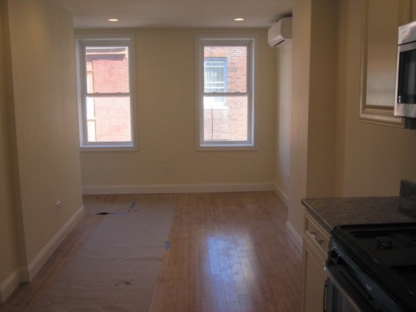 6 Baldwin Place Boston, MA 02113 - Photo 7 of 7 an empty room with wooden floor and windows