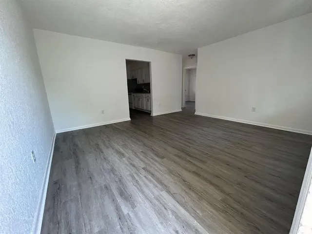 a view of a room with wooden floor and a sink