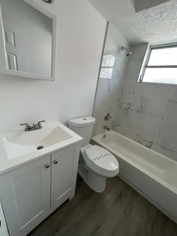 a bathroom with a double vanity sink toilet and a bathtub