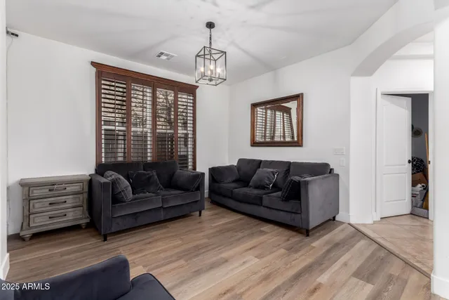 a living room with furniture and a chandelier