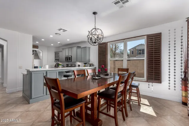 a kitchen with stainless steel appliances granite countertop a sink a stove a refrigerator and cabinets