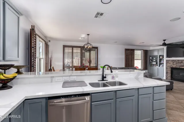 a kitchen with stainless steel appliances a sink a stove a microwave and cabinets