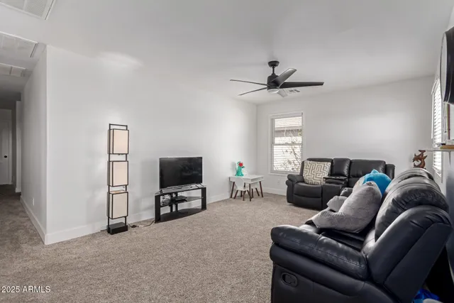 a living room with furniture and a clock