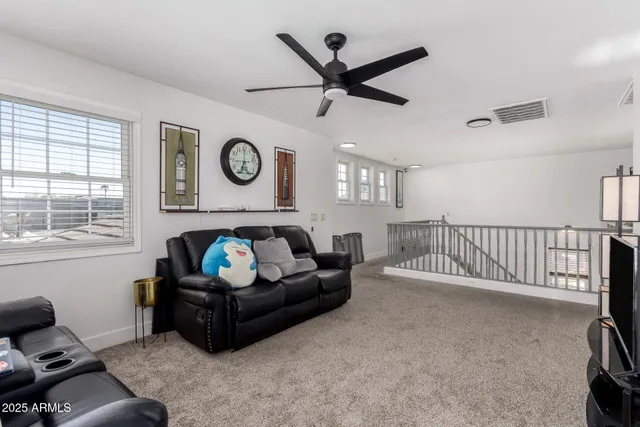 a living room with furniture a rug and a window