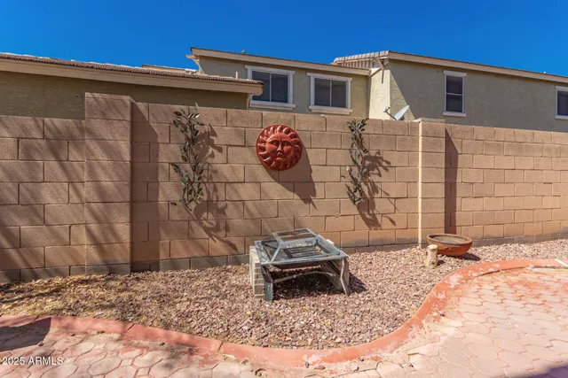 a view of a patio with a table and chairs and couches under an umbrella