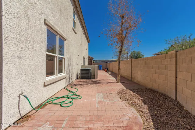 a backyard of a house with table and chairs