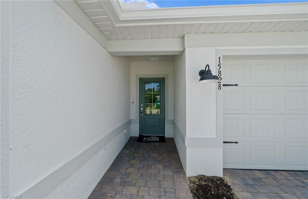 15828 Northridge Road Punta Gorda, FL 33982 - Photo 4 of 44 a view of a hallway with a white walls and a window