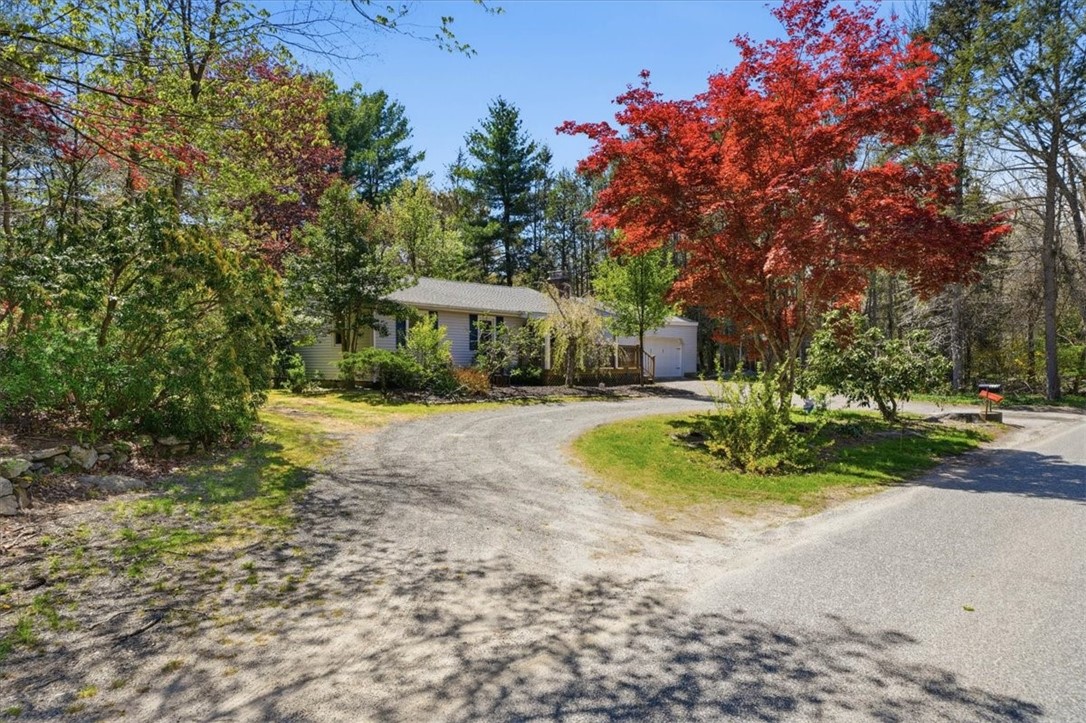 322 Rocky Hill Road Scituate, RI 02857 - Photo 4 of 50 Enjoy outdoor living from the grand farmer’s porch with gated entry, all set on a .27-acre lot with a generous pull-through driveway and peaceful wooded backdrop.
