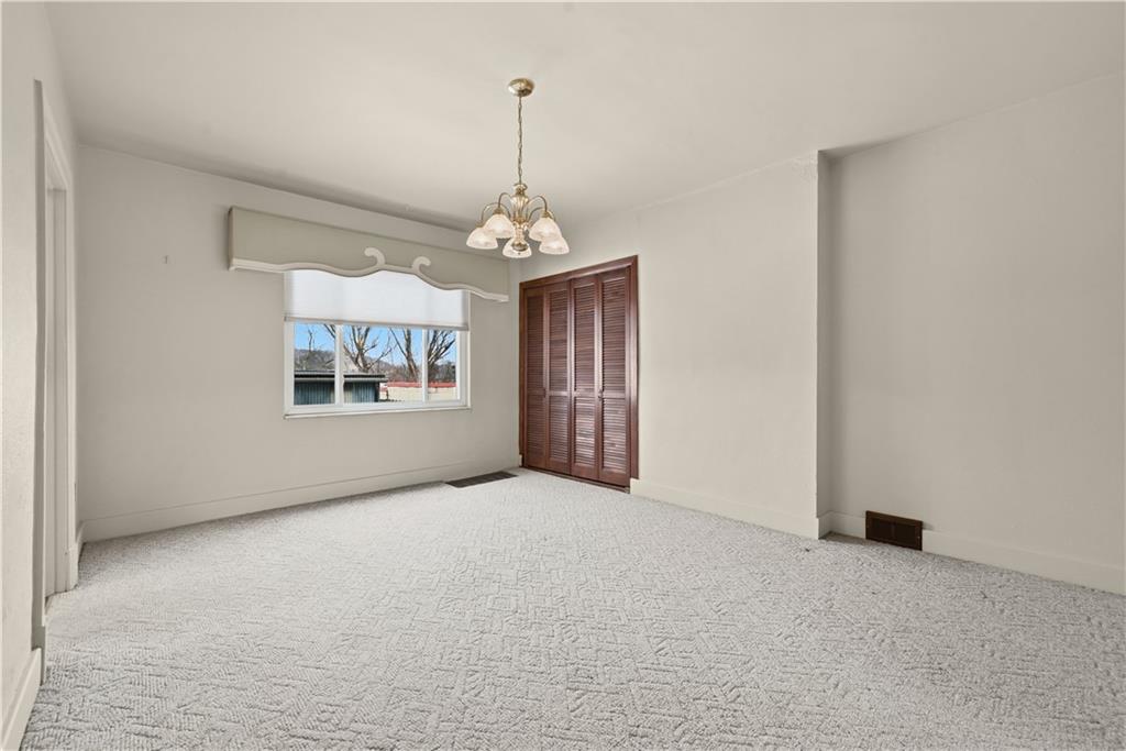 7215 Whipple Street Pittsburgh, PA 15218 - Photo 13 of 46 a view of a big room with windows and chandelier