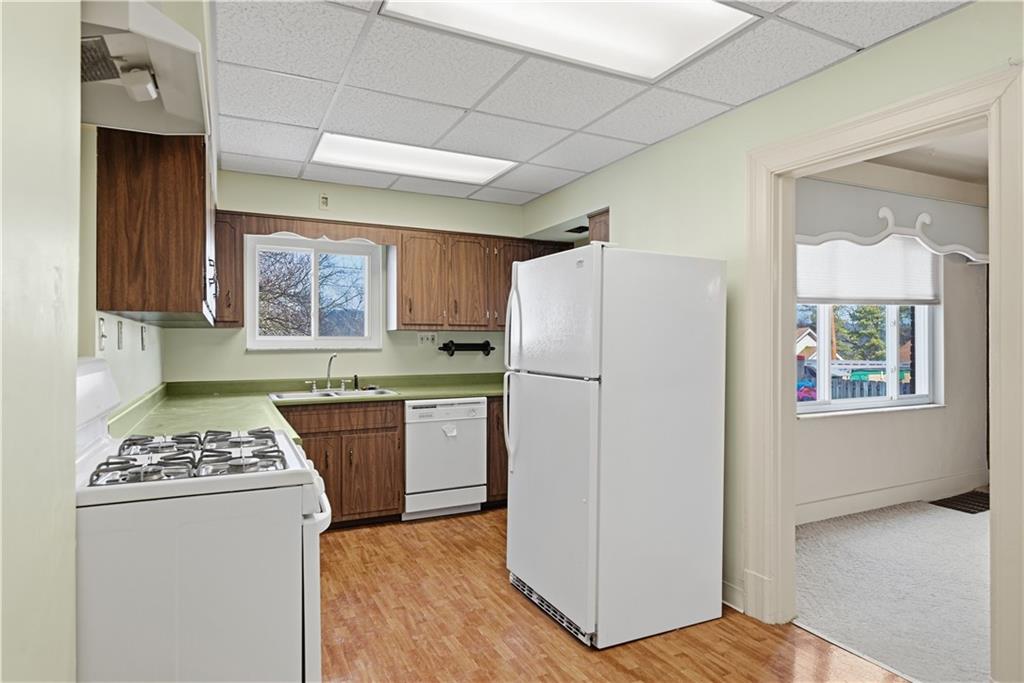 7215 Whipple Street Pittsburgh, PA 15218 - Photo 16 of 46 a kitchen with a refrigerator and a stove top oven