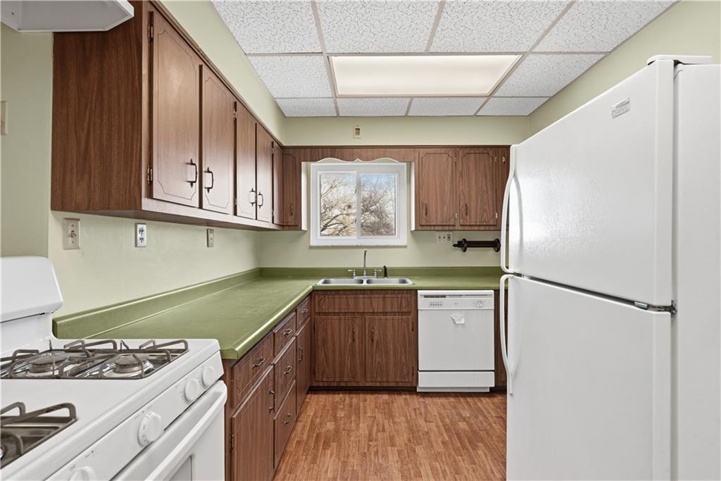 7215 Whipple Street Pittsburgh, PA 15218 - Photo 17 of 46 a kitchen with a stove a refrigerator and a sink