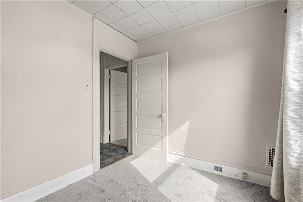 7215 Whipple Street Pittsburgh, PA 15218 - Photo 23 of 46 a view of an empty room with wooden floor and a window