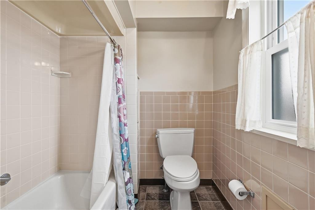 7215 Whipple Street Pittsburgh, PA 15218 - Photo 30 of 46 a bathroom with a toilet and a shower curtain