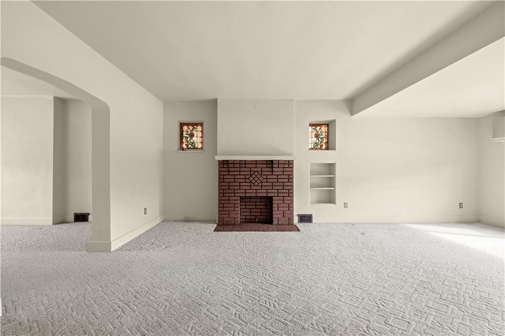 7215 Whipple Street Pittsburgh, PA 15218 - Photo 7 of 46 an empty room with furniture and a fireplace
