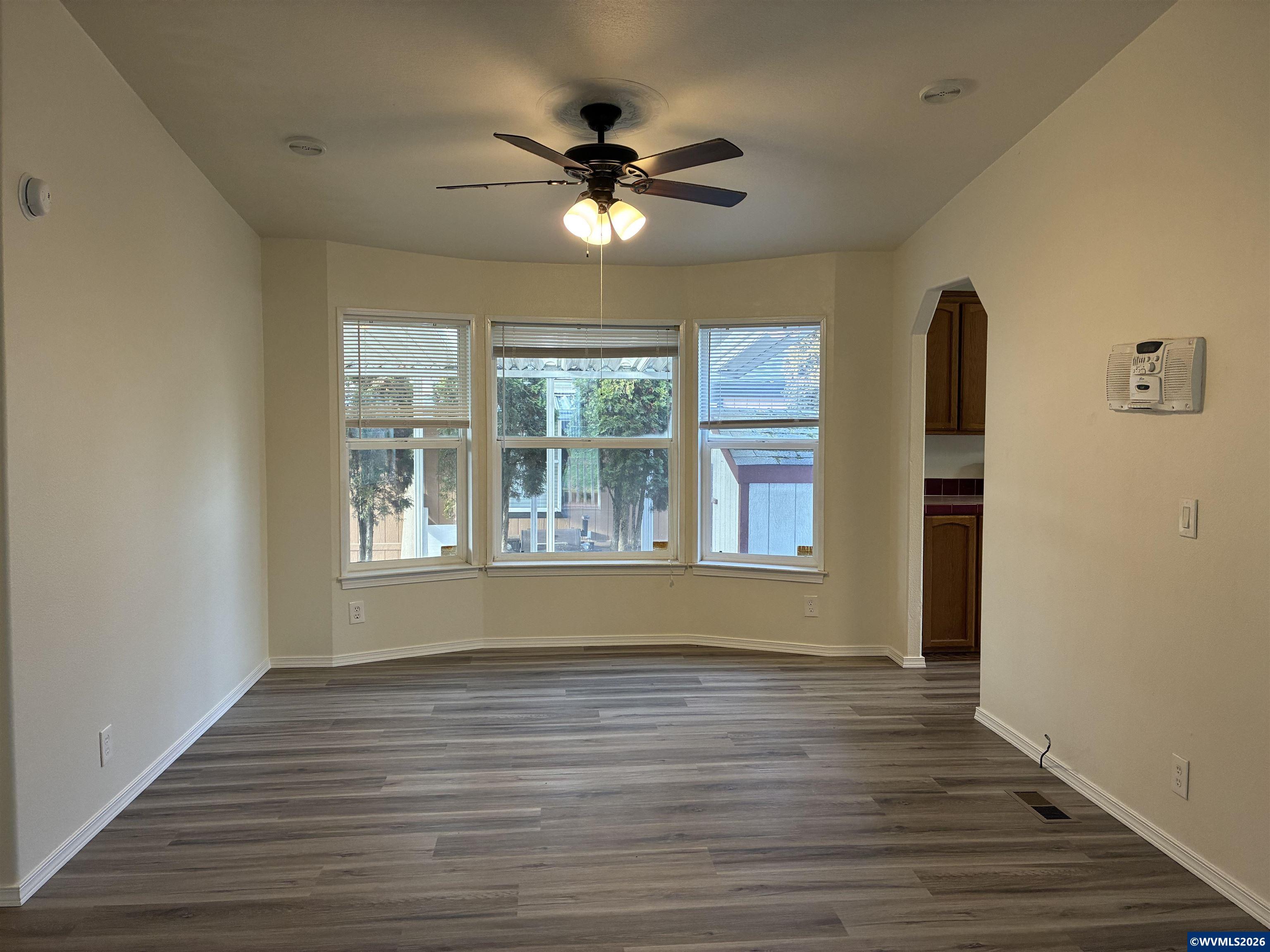 2000 Robins Lane Southeast, Unit 7 Salem, OR 97306 - Photo 11 of 39 a view of an empty room with wooden floor and a window