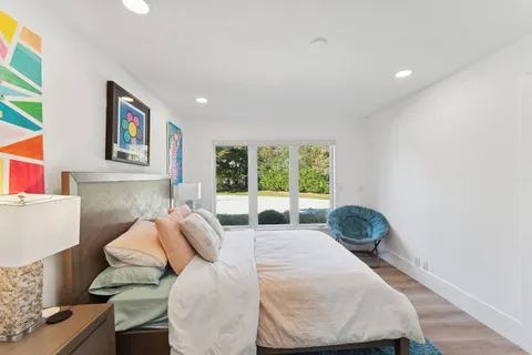 a living room with a flat screen tv and a floor to ceiling window