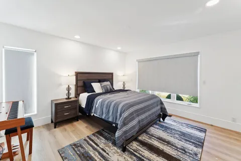 a spacious bedroom with a bed and a large window