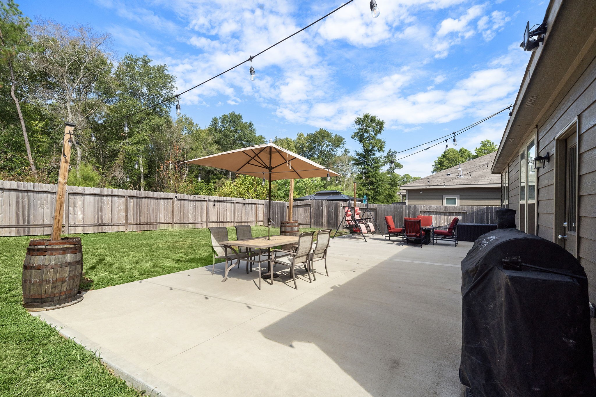 4210 Amber Ruse Drive Conroe, TX 77304 - Photo 41 of 45 Spacious backyard with a large patio, ideal for entertaining.