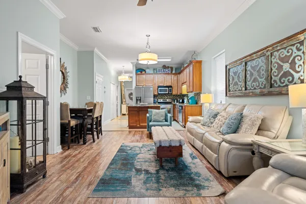 a living room with furniture dining area and a chandelier