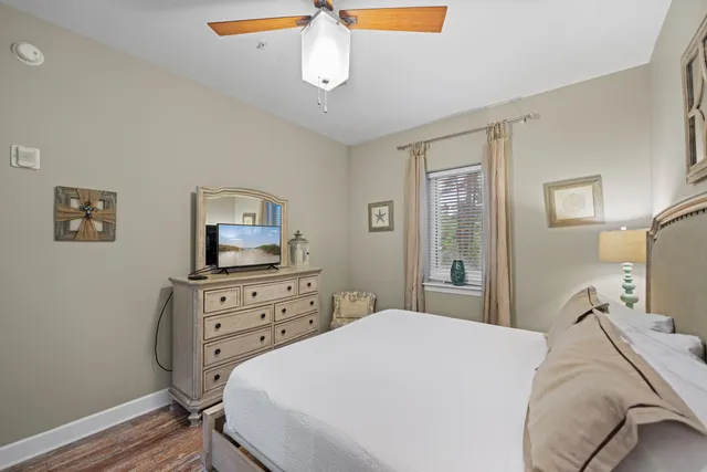 a bedroom with a bed and a flat tv screen on dresser