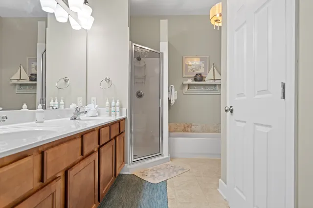 a bathroom with a granite countertop sink mirror and a bathtub