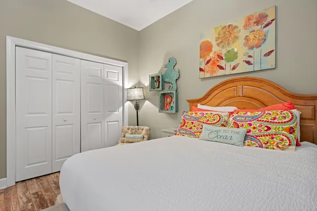 a bedroom with a bed and painting on the wall