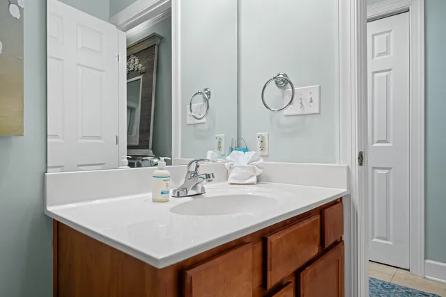 a bathroom with a sink vanity and a mirror