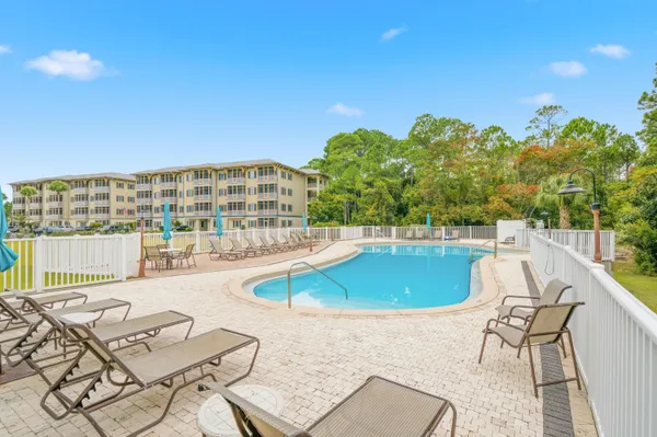 a view of a swimming pool with lounge chairs
