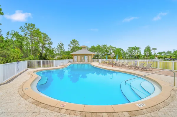 a view of a swimming pool with a lounge chair