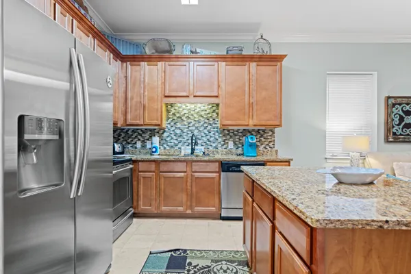 a kitchen with stainless steel appliances granite countertop a sink stove and refrigerator