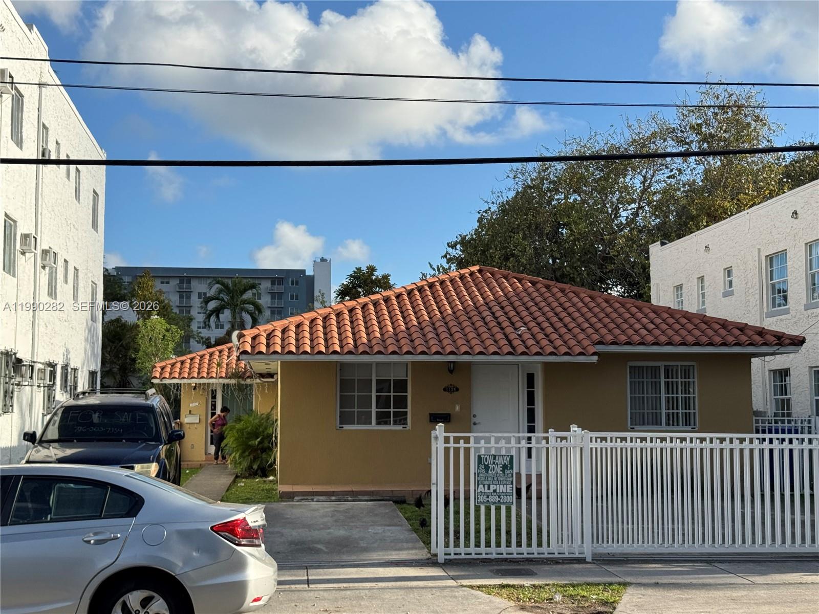 1124 Northwest 3rd Street Miami, FL 33128 - Photo 1 of 5 a front view of a house with a porch