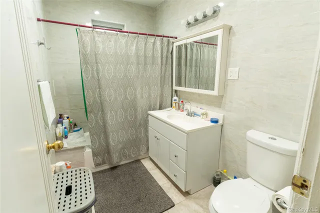 a bathroom with a sink a toilet and shower curtain