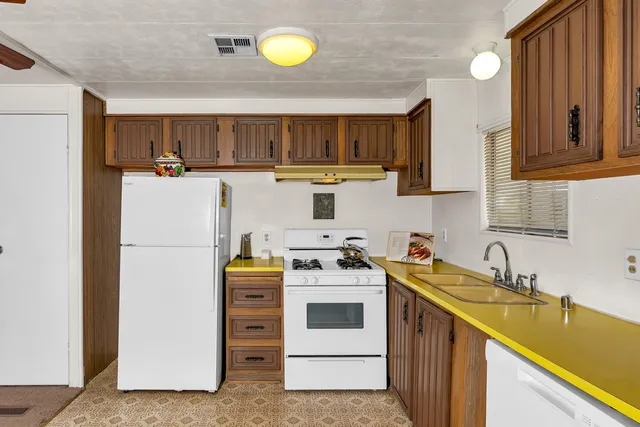 a kitchen with a white cabinets and white appliances