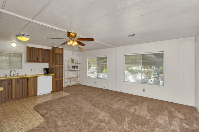 a big room with chandelier and windows