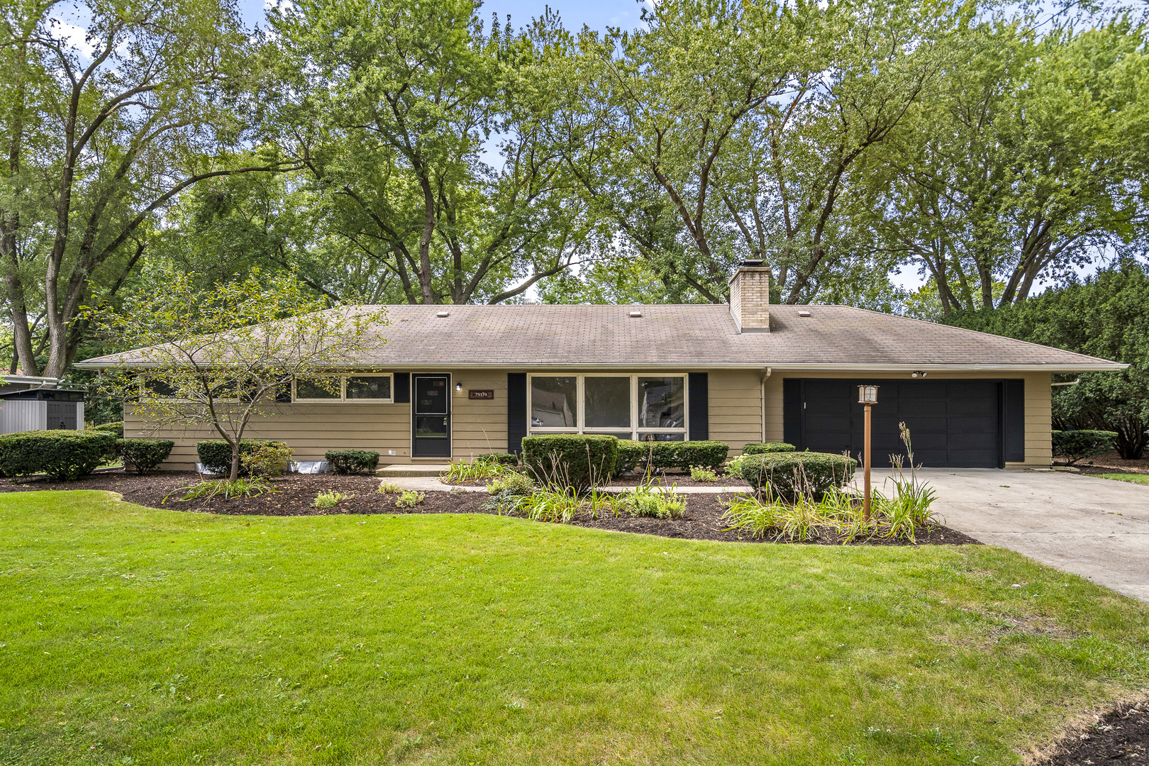 7S174 Wild Cherry Road Naperville, IL 60540 - Photo 1 of 25 a front view of a house with garden