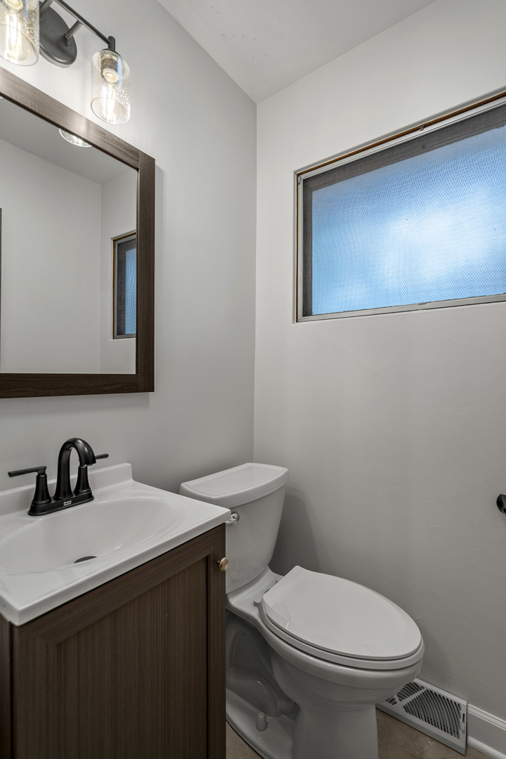 7S174 Wild Cherry Road Naperville, IL 60540 - Photo 16 of 25 a bathroom with a toilet sink and mirror