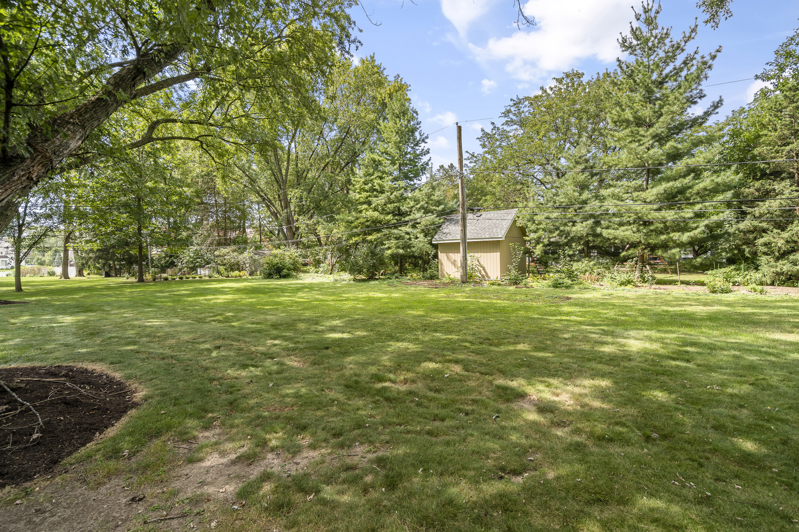 7S174 Wild Cherry Road Naperville, IL 60540 - Photo 23 of 25 a large yard with lots of green space and trees