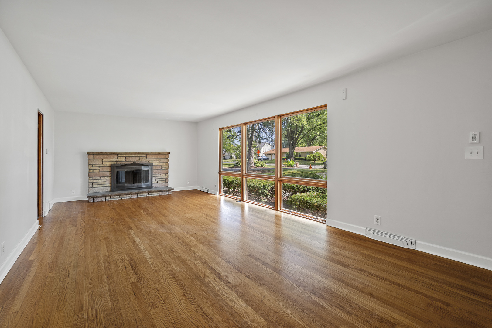 7S174 Wild Cherry Road Naperville, IL 60540 - Photo 25 of 25 a view of an empty room with wooden floor and a window