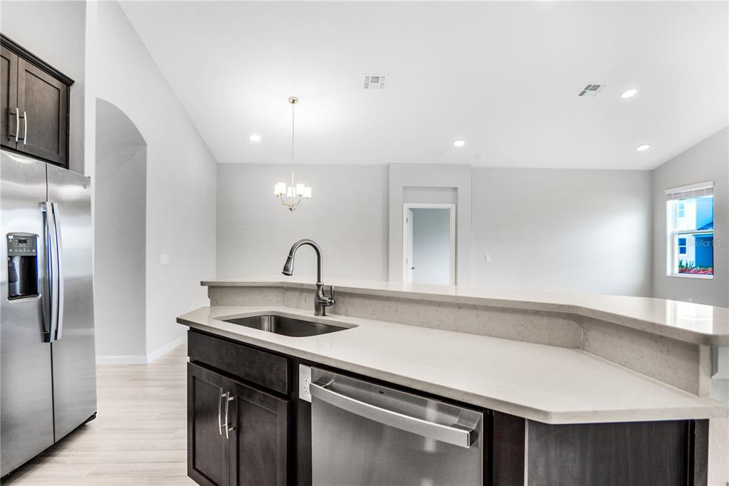 5286 Teirgarten Street St. Cloud, FL 34771 - Photo 15 of 26 a kitchen with a sink and refrigerator