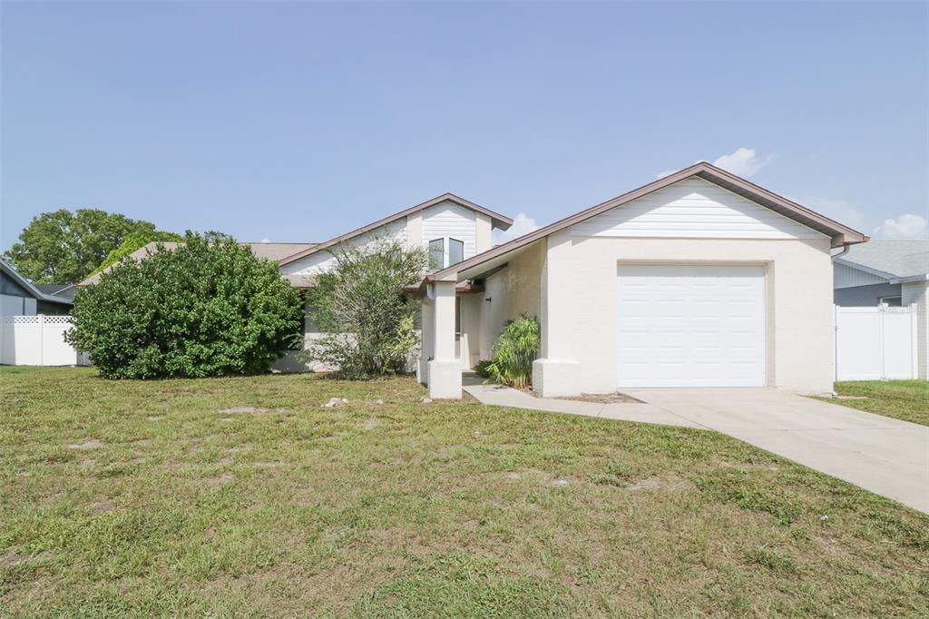 7830 Seasons Lane New Port Richey, FL 34653 - Photo 1 of 1 a view of a house with a yard and potted plants