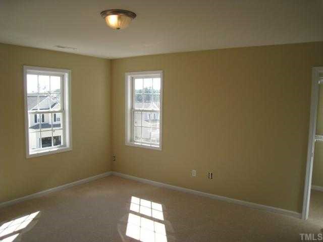 4241 Beacon Crest Way Raleigh, NC 27604 - Photo 8 of 9 Master bedroom offers brushed nickel lighting, accent wall color, & walk-in closet!